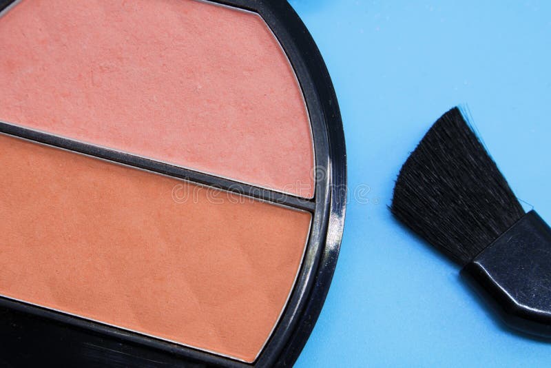 Cosmetici per trucco, un barattolo con il primo piano del rossetto accanto ad una spazzola per trucco su un fondo blu, truccatore fotografie stock Cosmetici per trucco, un barattolo con il primo piano del rossetto accanto ad una spazzola per trucco su un fondo blu, truccatore fotografie stock