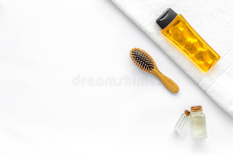 Cosmetics for hair care with jojoba, argan or coconut oil in bottle on white background top view mockup royalty free stock photo Cosmetics for hair care with jojoba, argan or coconut oil in bottle on white background top view mockup royalty free stock photo