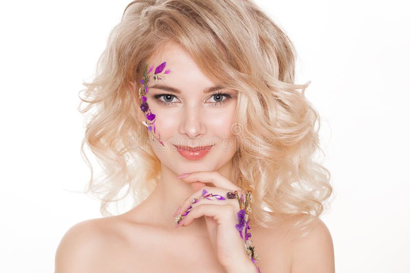 Cosmetics and manicure. Close-up portrait of attractive woman with dry flowers on her face, pastel color of nail design royalty free stock photo Cosmetics and manicure. Close-up portrait of attractive woman with dry flowers on her face, pastel color of nail design royalty free stock photo
