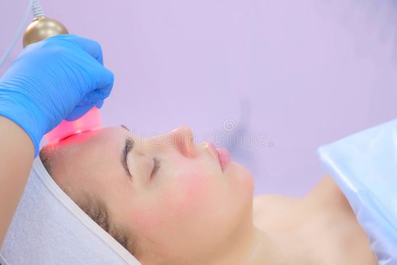 Cosmetologist Doctor Making Phonophoresis Procedure On Woman Face Side