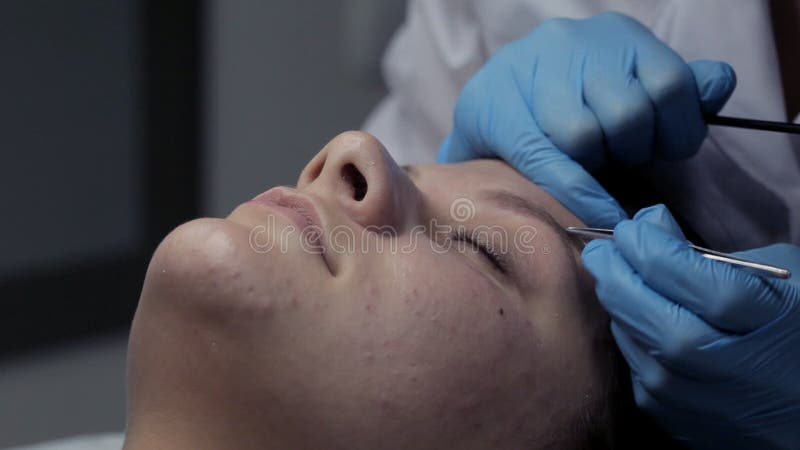 Cosmetologist makes eyebrow correction to client. Cosmetologist makes video