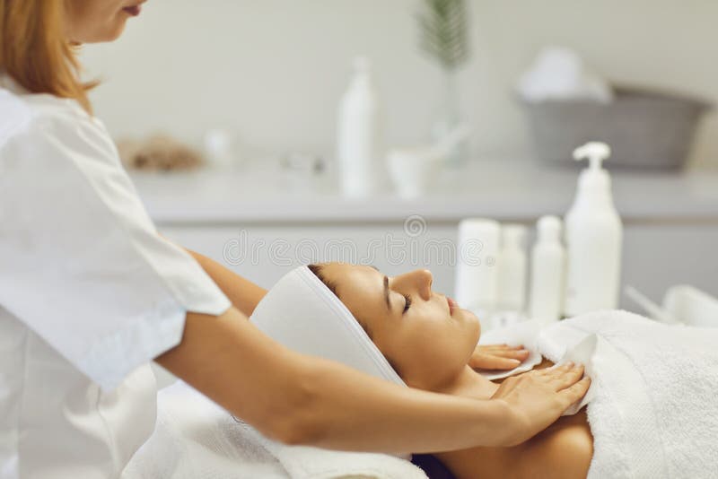 Cosmetologist Wiping Relaxing Womans Neck And Shoulders After Facial Massage In Spa Salon Stock