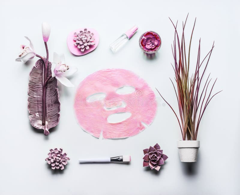 Modern skin care cosmetics composing with pink facial sheet mask . Beauty flat lay on white background, top view. Natural cosmetic concept. Modern skin care cosmetics composing with pink facial sheet mask . Beauty flat lay on white background, top view. Natural cosmetic concept