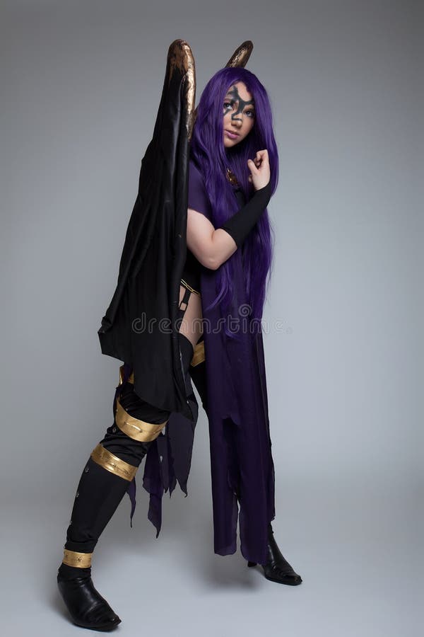 Girl stand in purple witch cosplay costume anime character. Girl stand in purple witch cosplay costume anime character