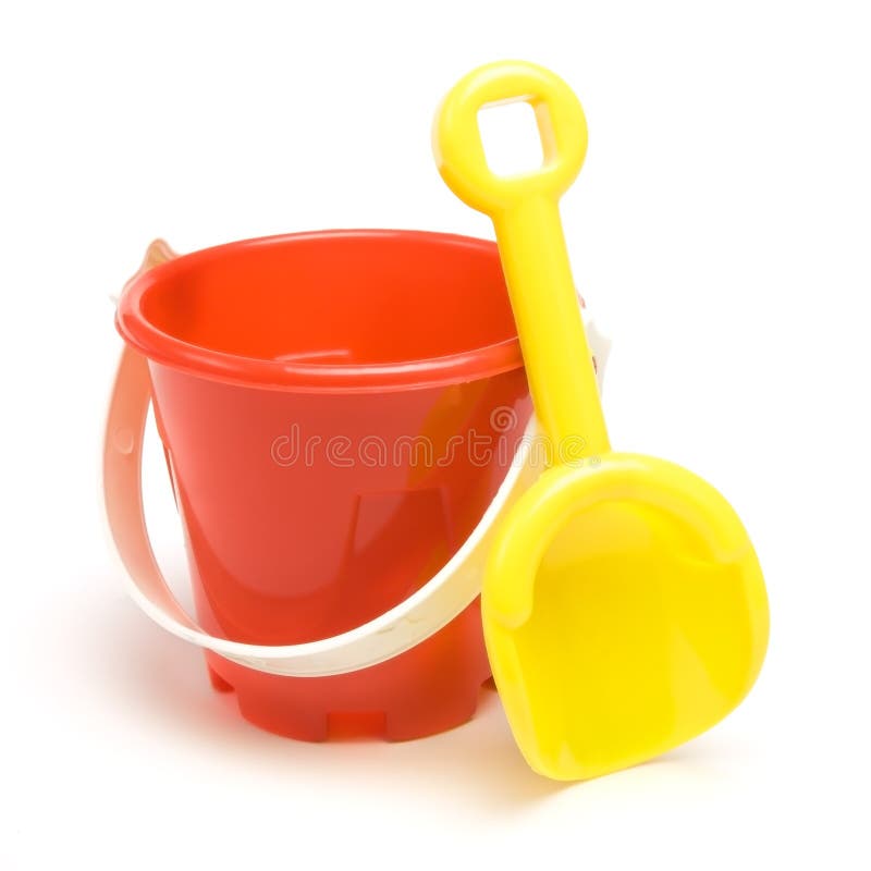 Kids red bucket and yellow spade summer holiday concept isolated against white background. Kids red bucket and yellow spade summer holiday concept isolated against white background.