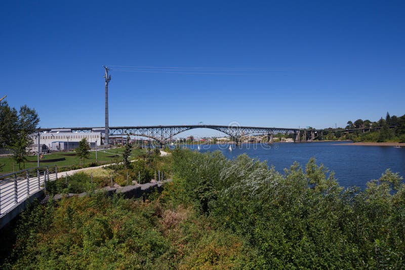 PORTLAND, OR - JULY 27, 2016: Public greenway park with bike paths at the South Waterfront District in Portland Oregon. PORTLAND, OR - JULY 27, 2016: Public greenway park with bike paths at the South Waterfront District in Portland Oregon.