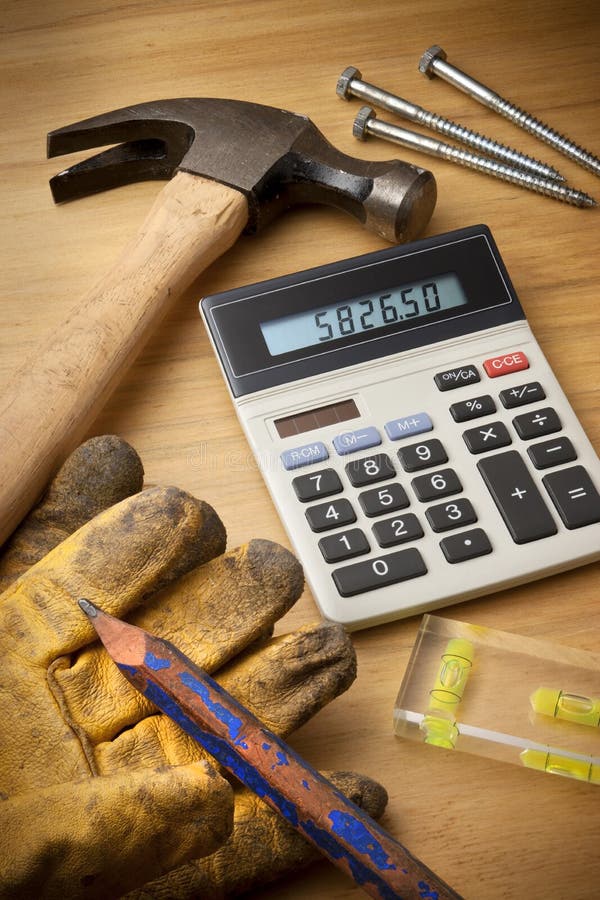 A still-life with building tools, hammer, pencil, level, calculator, screws. A still-life with building tools, hammer, pencil, level, calculator, screws