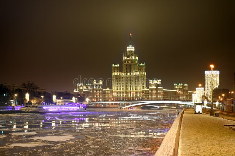 MOSCOW, RUSSIA - Glowing Kotelnicheskaya Embankment Building on New Year’s Eve. Night Moscow cityscape with view on river Moskva Moscow and the illuminated residential high-rise building. MOSCOW, RUSSIA - Glowing Kotelnicheskaya Embankment Building on New Year’s Eve. Night Moscow cityscape with view on river Moskva Moscow and the illuminated residential high-rise building.