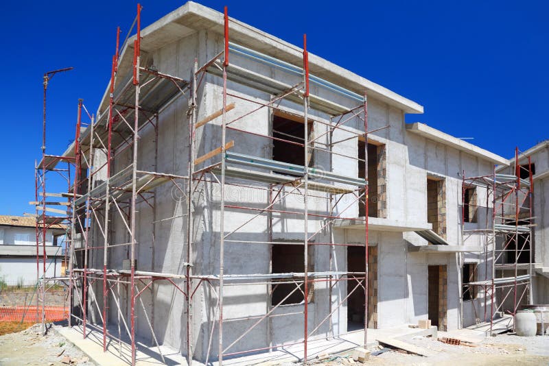 Construction of building of new two-story white concrete house with stairs and balcony. Construction of building of new two-story white concrete house with stairs and balcony