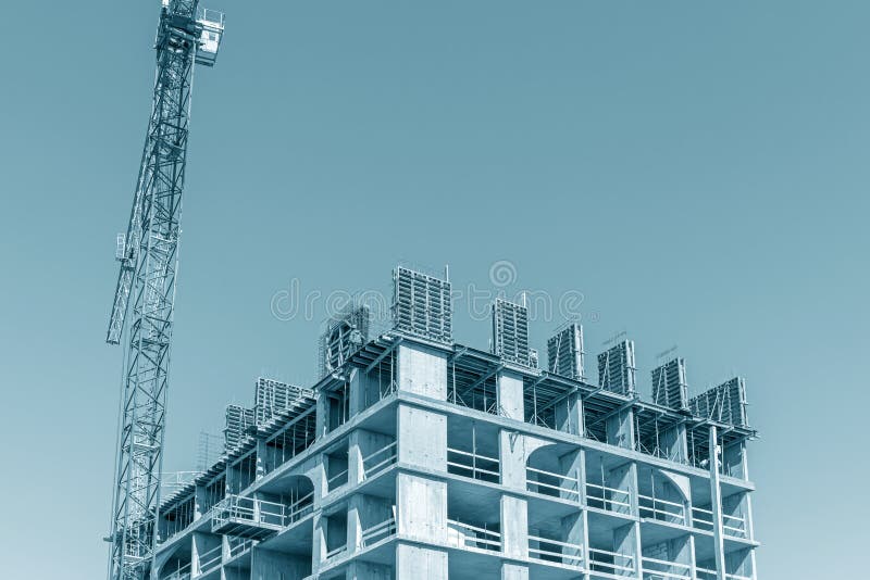 Costruzione non finita con il falsework contro il fondo del cielo blu fotografia stock Costruzione non finita con il falsework contro il fondo del cielo blu fotografia stock
