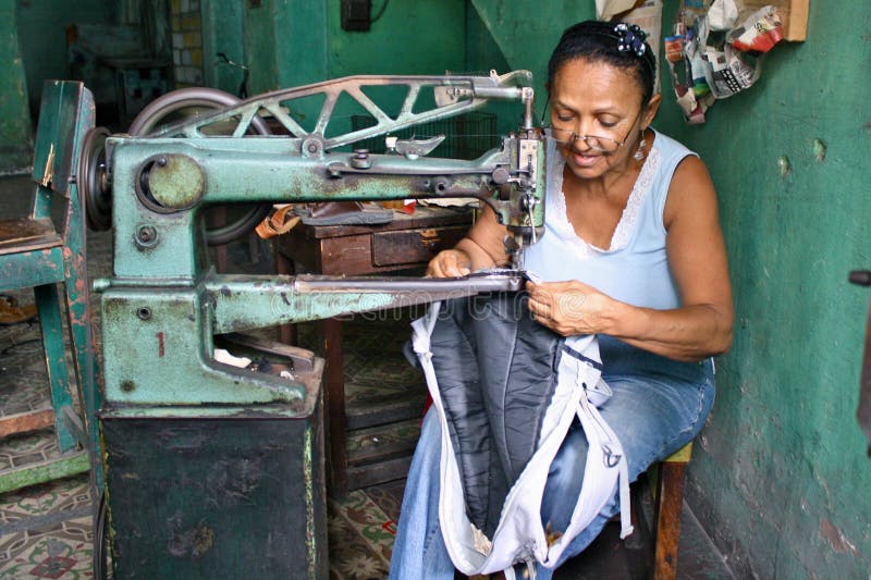 Cuban woman sewing on a very old sewing machine, Havana, Cuba. Cuban woman sewing on a very old sewing machine, Havana, Cuba