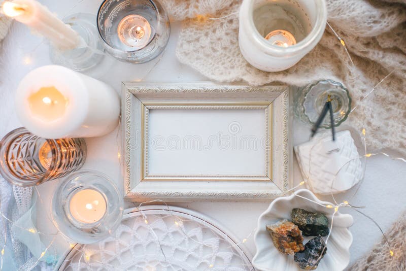 Cosy and soft winter spring white monochrome background, knitted scarf, dream catcher and candles on white. Christmas holidays, stock photo Cosy and soft winter spring white monochrome background, knitted scarf, dream catcher and candles on white. Christmas holidays, stock photo
