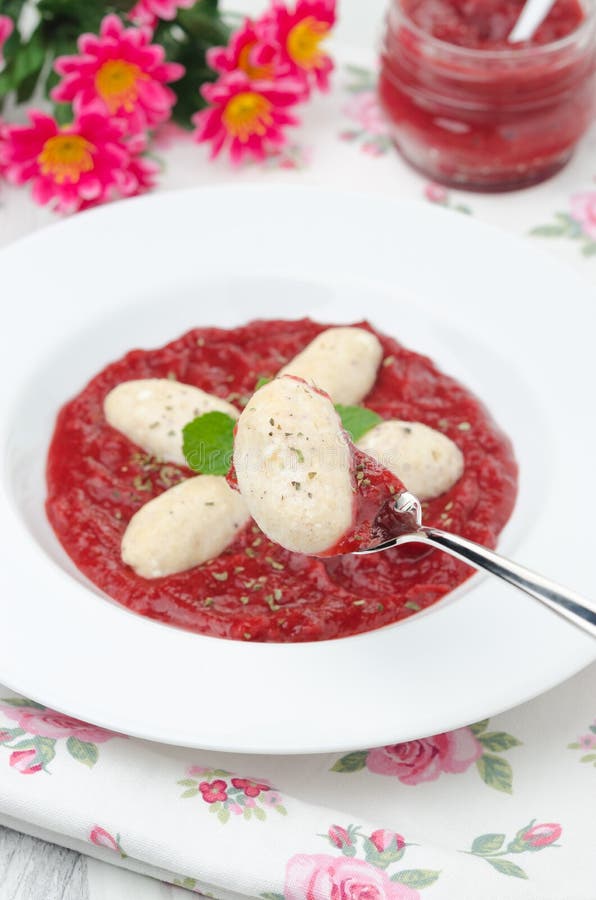Cottage Cheese Gnocchi with Strawberry Sauce on a Fork Vertical Stock