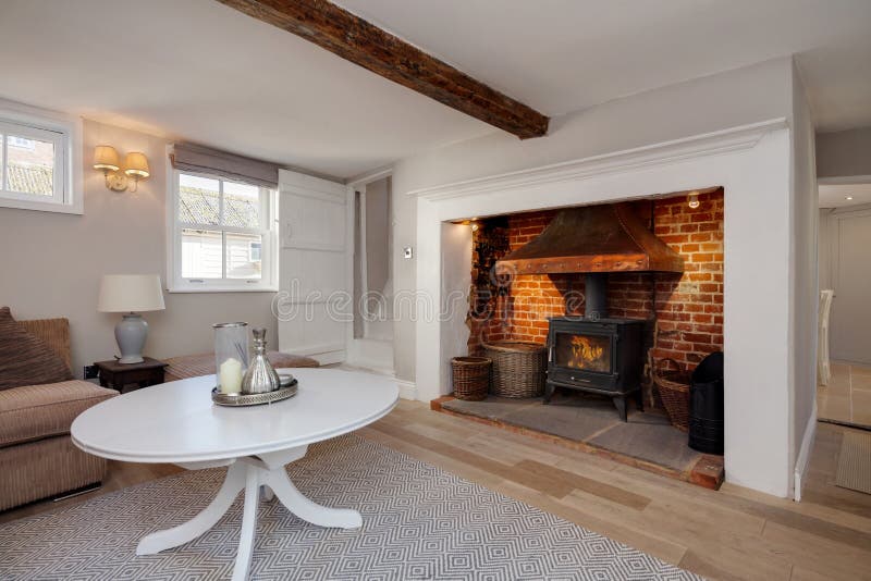 Cottage living room with fireplace and stove stock photos Cottage living room with fireplace and stove stock photos