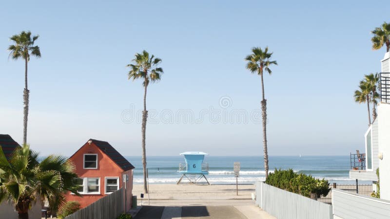 Cottages in Oceanside California USA. Beachfront bungalows. Ocean beach palm trees. Lifeguard tower.