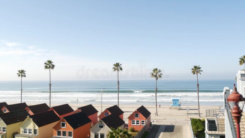 Cottages in Oceanside California USA. Beachfront bungalows. Ocean beach palm trees. Lifeguard tower.