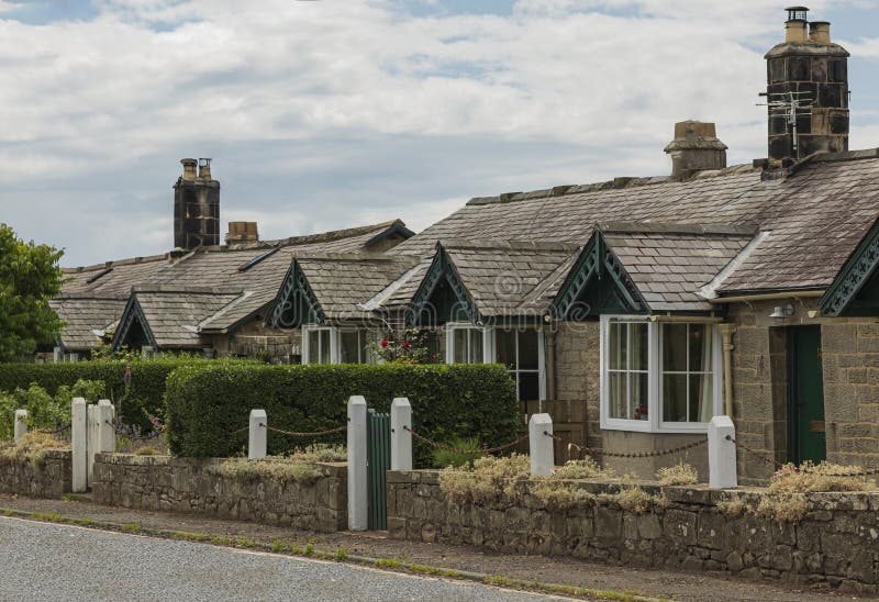 Cottages painted dark green in a terrace stock images