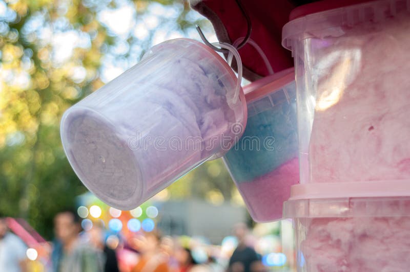Cotton Candy Containers Hanging from a Funfair Stand with Blurred