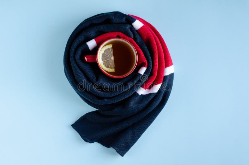 Cotton Colored Scarf with Tea Cup and Lemon Slice Composition on Blue Background Stock Image
