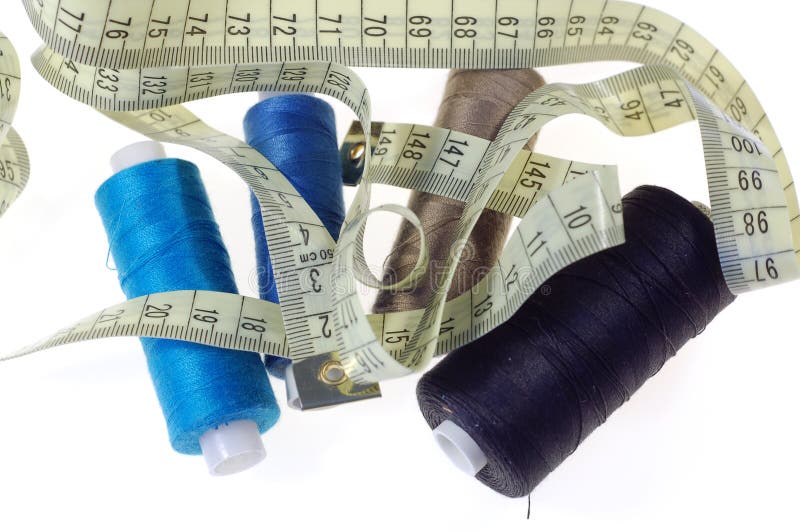 Colourful cotton thread and measure tape on pure white background. Colourful cotton thread and measure tape on pure white background