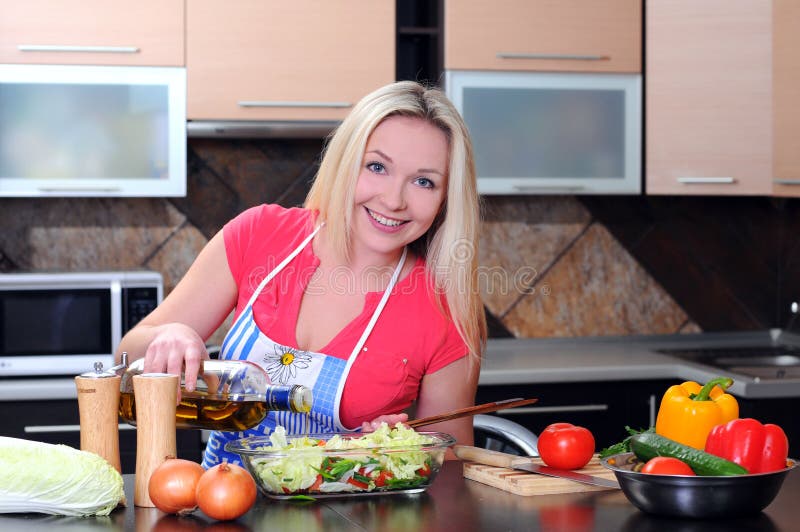 Young Woman Cooking. Healthy Food - Vegetable Salad. Diet. Dieting Concept. Healthy Lifestyle. Cooking At Home. Prepare Food. Young Woman Cooking. Healthy Food - Vegetable Salad. Diet. Dieting Concept. Healthy Lifestyle. Cooking At Home. Prepare Food