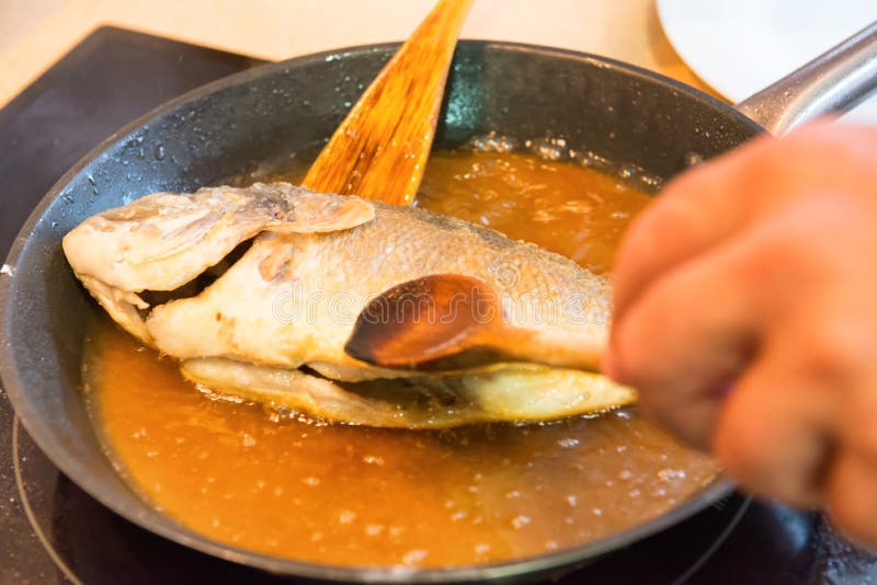 Cottura del pesce fritto fotografie stock libere da diritti Cottura del pesce fritto fotografie stock libere da diritti