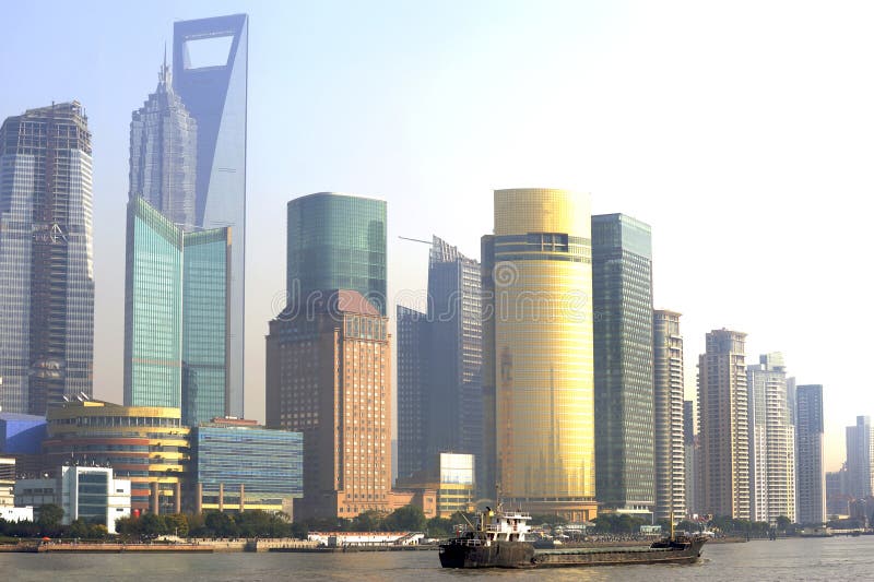 Skyline of the financial district of Shanghai with offices and hotels.In front boats at the Huangpu river. Skyline of the financial district of Shanghai with offices and hotels.In front boats at the Huangpu river