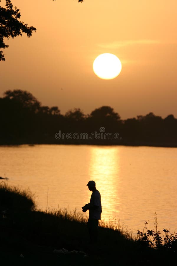 Fisherman at sunset in Africa along a river. Fisherman at sunset in Africa along a river