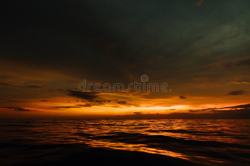 Coucher du soleil sombre en mer de soirée Beau coucher du soleil en ciel nuageux sur l'océan photographie stock libre de droits Coucher du soleil sombre en mer de soirée Beau coucher du soleil en ciel nuageux sur l'océan photographie stock libre de droits