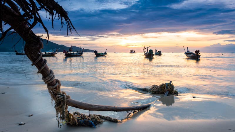 Coucher du soleil sur la plage avec le bateau de pêche à Phuket, Thaïlande image stock Coucher du soleil sur la plage avec le bateau de pêche à Phuket, Thaïlande image stock