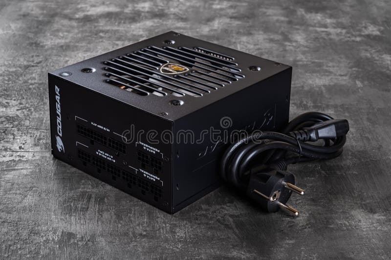 Cougar GEX 80 Plus Gold certified PSU and power cord on a dark background. 850W modular power supply unit with flawless power royalty free stock photography