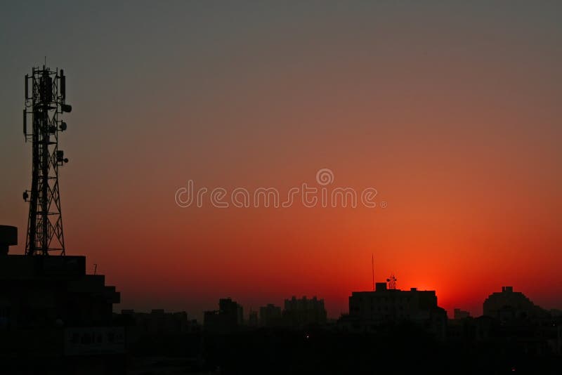 silhouetted sunsets and sunsrise hues in modern cities. silhouetted sunsets and sunsrise hues in modern cities