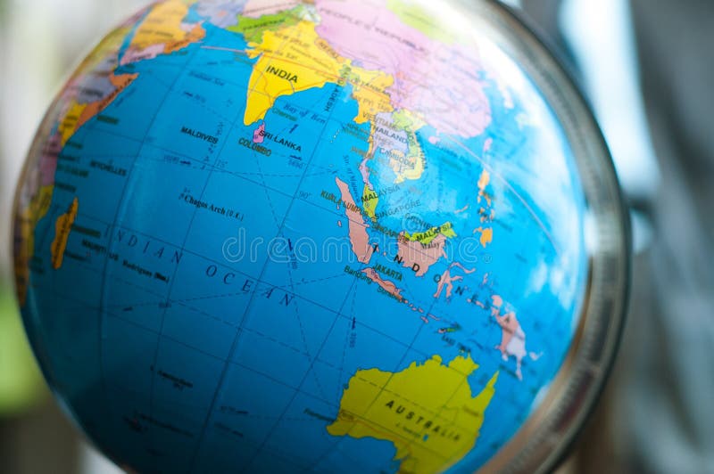 Countries and continents close up with the color map on a globe with books in the background. stock image Countries and continents close up with the color map on a globe with books in the background. stock image