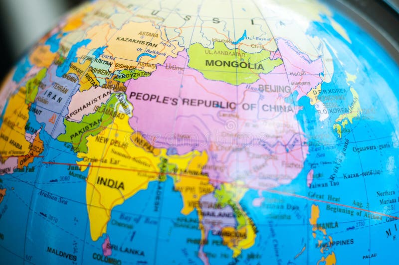 Countries and continents close up with the color map on a globe with books in the background. royalty free stock photos Countries and continents close up with the color map on a globe with books in the background. royalty free stock photos