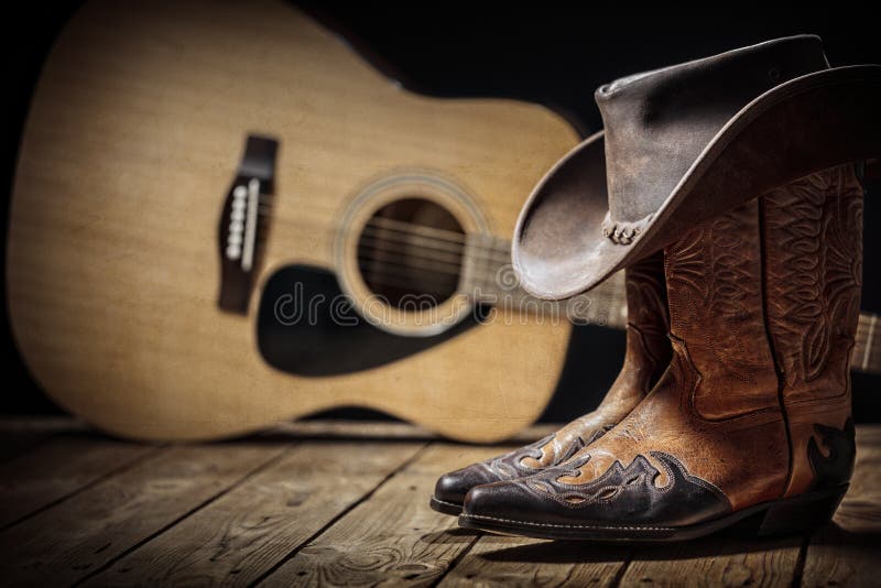 Country music festival live concert with acoustic guitar, cowboy hat and boots. Background