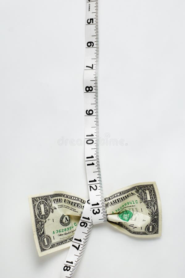 Dollar being squeezed by a tape measurer. Dollar being squeezed by a tape measurer.