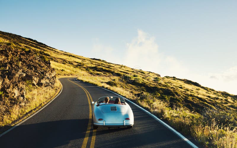 Happy Couple Driving on Country Road in Classic Vintage Sports Car. Happy Couple Driving on Country Road in Classic Vintage Sports Car