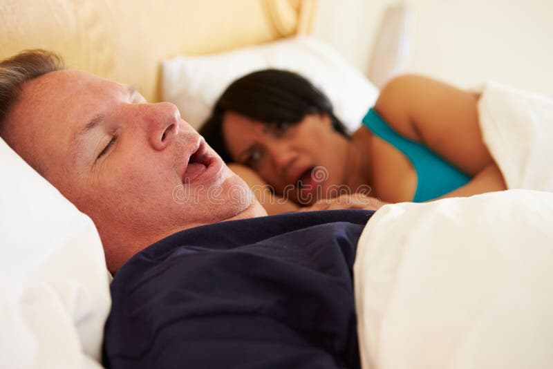 Couple Asleep In Bed With Man Snoring