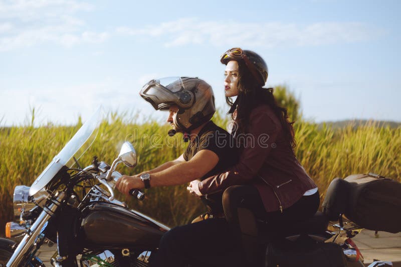 Couple on the Background of the Field Rides a Motorcycle. a Man in a Helmet  Rolls His Girlfriend in a Safety Helmet. Road Safety. Stock Photo - Image  of motorcycle, freedom: 153245682