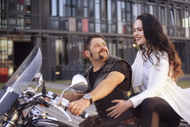 Couple on the Background of the Office on a Motorcycle. the Guy Brought His  Girlfriend To Work Stock Photo - Image of building, color: 153245848
