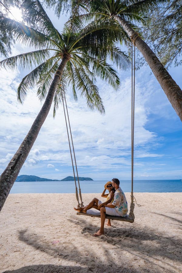 Couple On The Beach In Phuket Relaxing On Beach Chair Tropical Beach