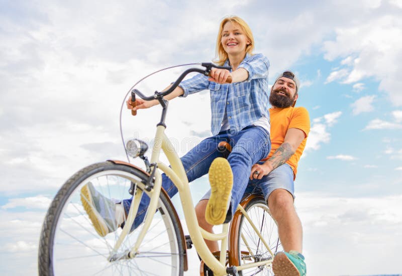 Couple with bicycle romantic date sky background. Couple in love date cycling. Explore city. Man and women rent bike to discover city as tourist. Bike rental or bike hire for short periods of time. Couple with bicycle romantic date sky background. Couple in love date cycling. Explore city. Man and women rent bike to discover city as tourist. Bike rental or bike hire for short periods of time.