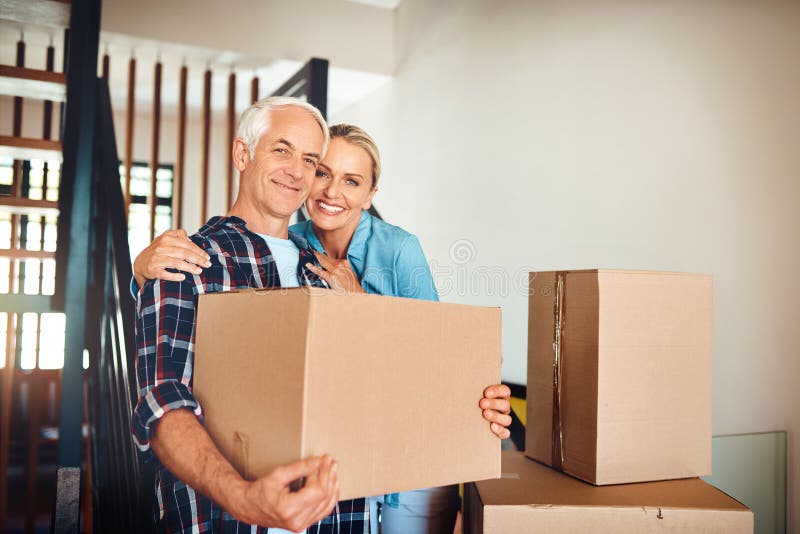 Couple, boxes and new home with portrait for real estate property and mortgage or bond approval. Happy mature man and stock images