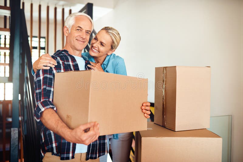 Couple, boxes and new house with portrait for real estate property and mortgage or bond approval. Happy mature man and stock image
