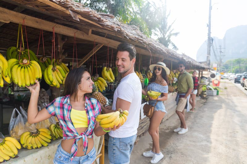 Couple Buying Bananas On Street Traditional Market, Young Man And Woman Travelers