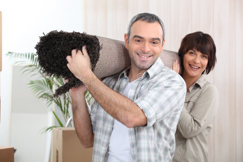 Couple carrying rug