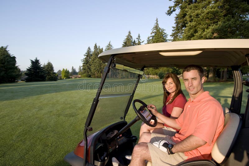 Couple in Cart on Golf Course - Horizontal