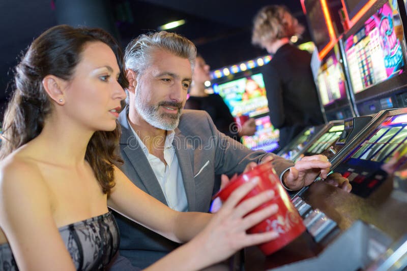 Couple in Casino on Slot Machine Stock Image - Image of automat ...