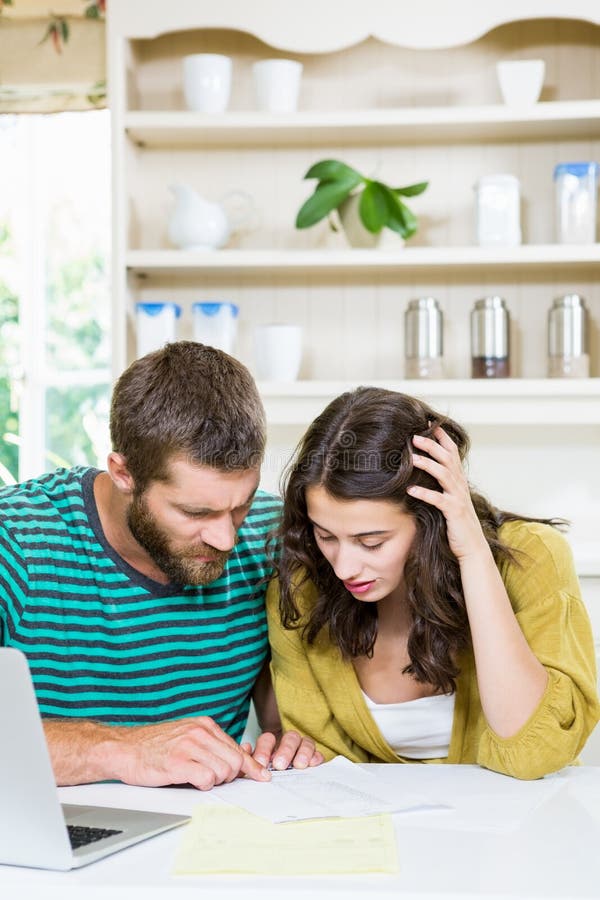 Couple Checking Their Bills in Kitchen Stock Image Image of documents