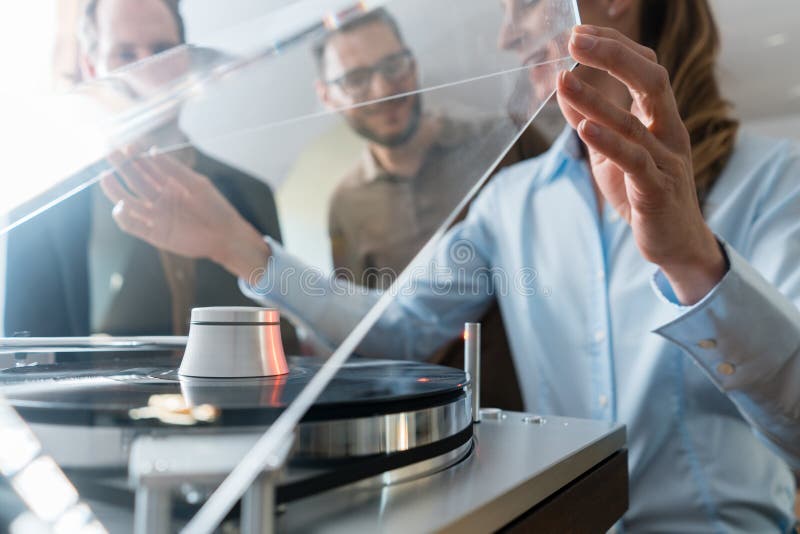 Couple choosing turntable record player in a store stock images Couple choosing turntable record player in a store stock images